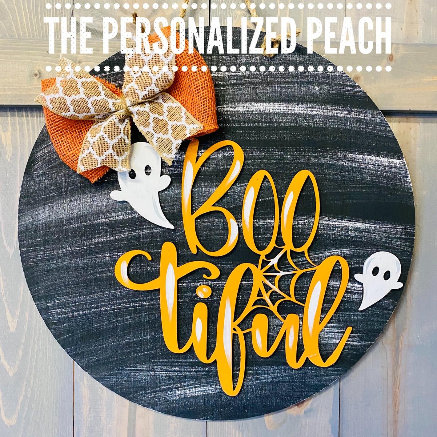 Painted wooden round Halloween door hanger with little ghosts and cute burlap ribbon. Reads Bootiful